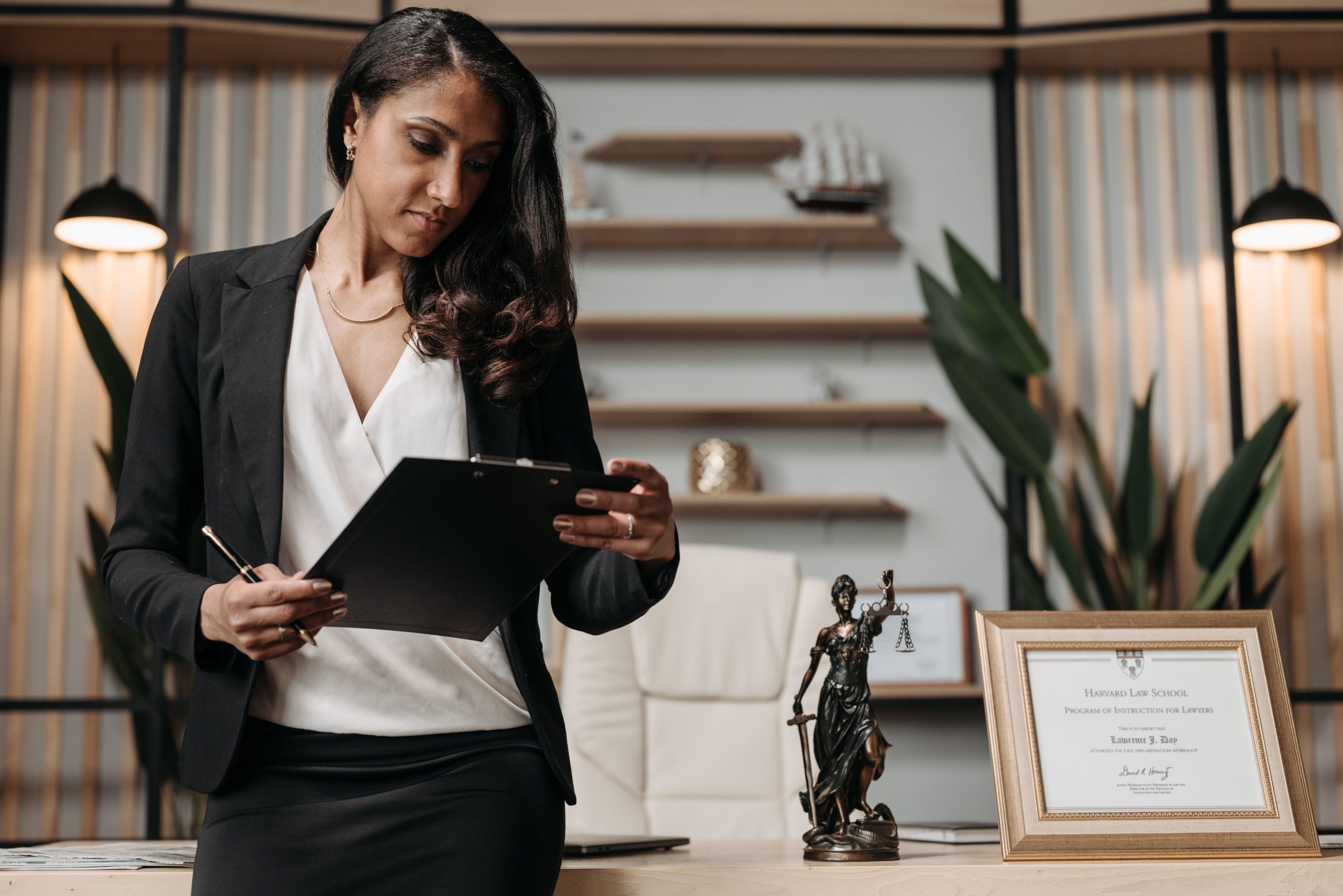 Legal professional reviewing paperwork at a desk, representing regulatory research for an environmental project.