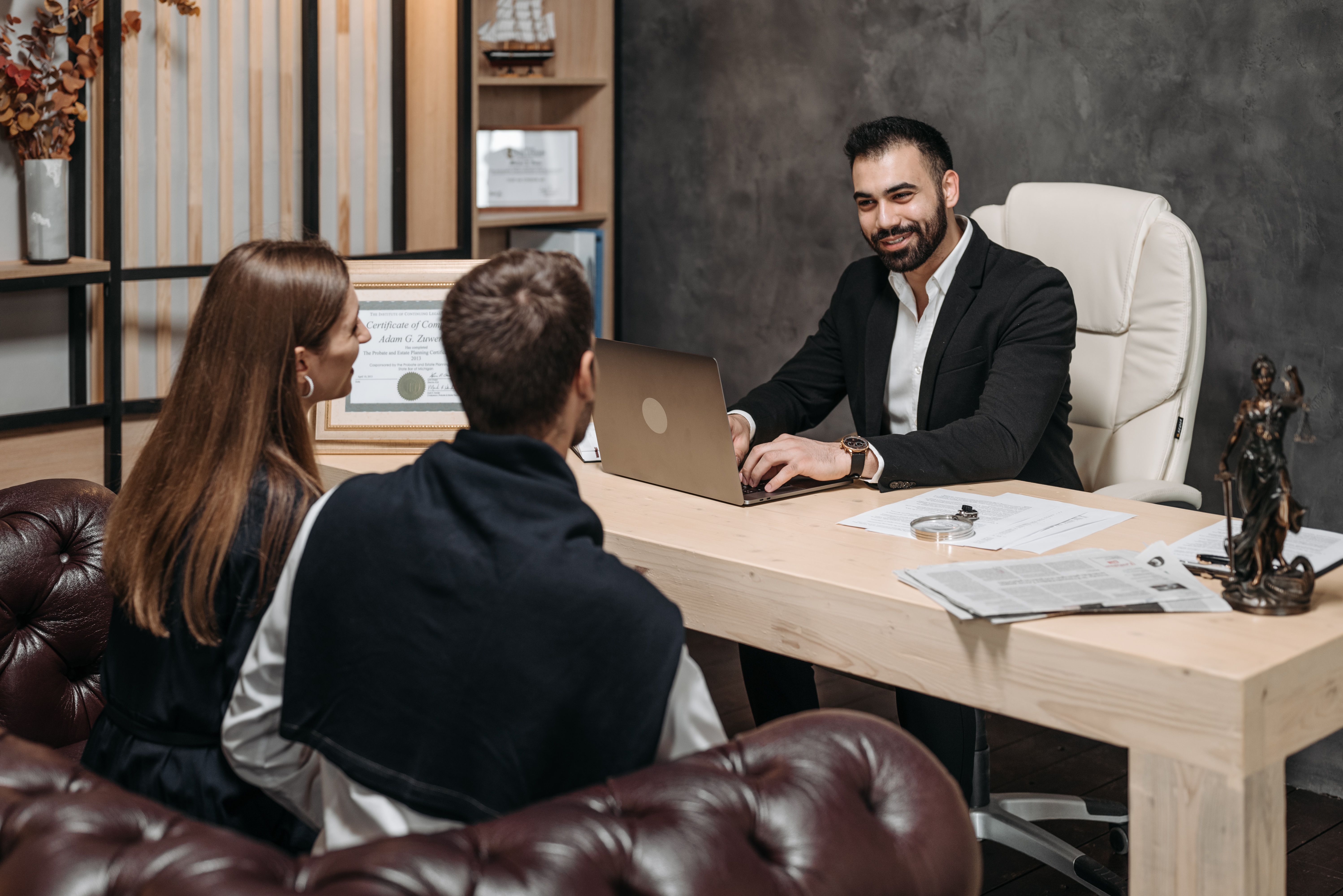 Lawyer consulting clients about their case in an upscale office after a change of legal representation